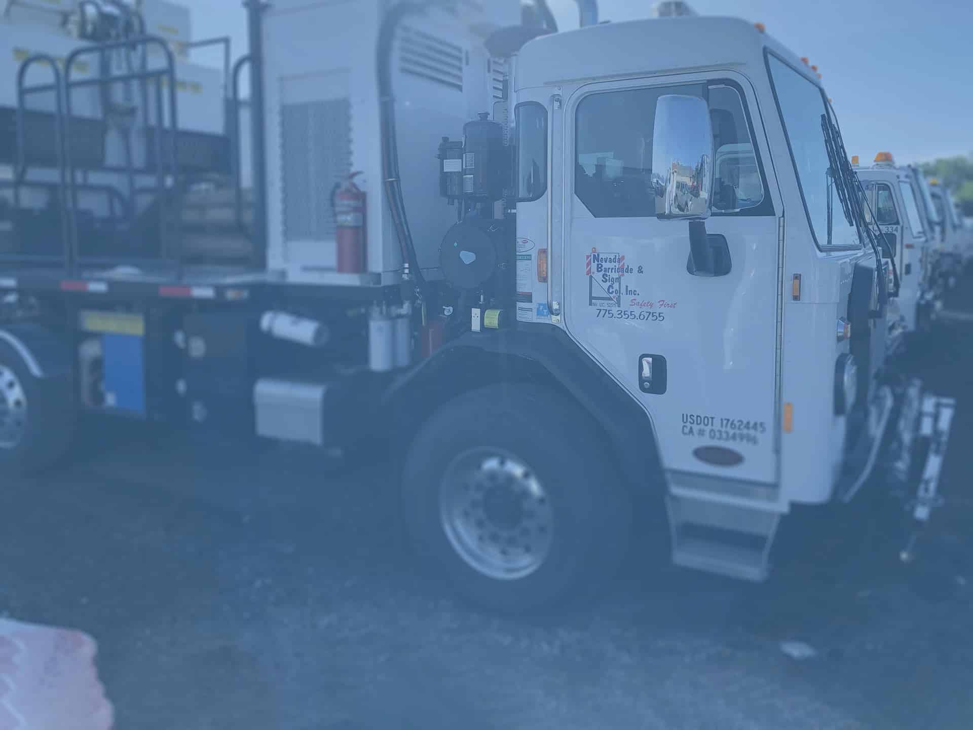 Nevada Barricade & Sign Company fleet truck with company branding, used for traffic control and road safety services.